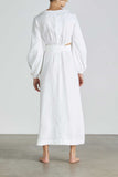 Woman wears BONDI BORN Belize long sleeve linen dress in White with puff sleeves and cut-out dress, shown from back